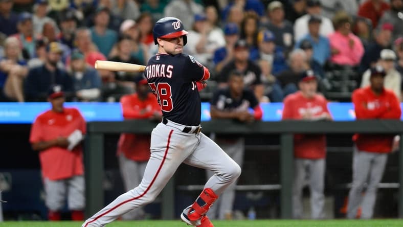 Jun 27, 2023; Seattle, Washington, USA; Washington Nationals right fielder Lane Thomas (28) hits a two run RBI double against the Seattle Mariners during the eleventh inning at T-Mobile Park. Mandatory Credit: Steven Bisig-USA TODAY Sports