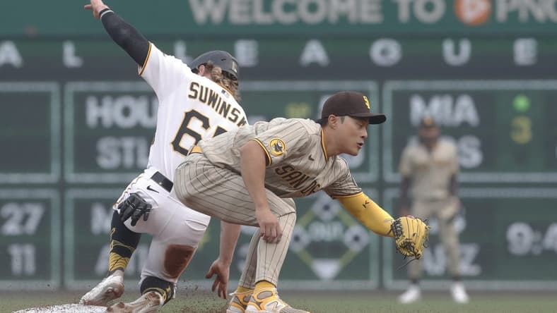 Jun 28, 2023; Pittsburgh, Pennsylvania, USA; Pittsburgh Pirates center fielder Jack Suwinski (65) steals second base as San Diego Padres second baseman Ha-Seong Kim (7) takes a late throw during the second inning at PNC Park. Mandatory Credit: Charles LeClaire-USA TODAY Sports