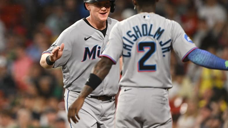 Jun 28, 2023; Boston, Massachusetts, USA; Miami Marlins first baseman Garrett Cooper (26) reacts with center fielder Jazz Chisholm Jr. (2) after scoring run against the Boston Red Sox during the sixth inning at Fenway Park. Mandatory Credit: Brian Fluharty-USA TODAY Sports