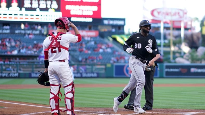 Jun 28, 2023; Anaheim, California, USA; Chicago White Sox center fielder Luis Robert Jr. (88) crosses home plate after hitting a home run in the first inning as Los Angeles Angels catcher Matt Thaiss (21) watches at Angel Stadium. Mandatory Credit: Kirby Lee-USA TODAY Sports