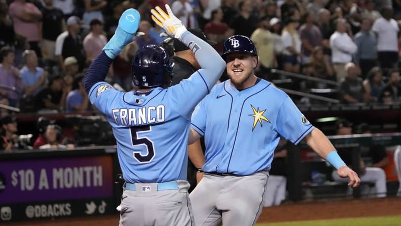 Jun 28, 2023; Phoenix, Arizona, USA; Tampa Bay Rays right fielder Luke Raley (55) and Tampa Bay Rays shortstop Wander Franco (5) celebrate after scoring runs against the Arizona Diamondbacks during the ninth inning at Chase Field. Mandatory Credit: Joe Camporeale-USA TODAY Sports