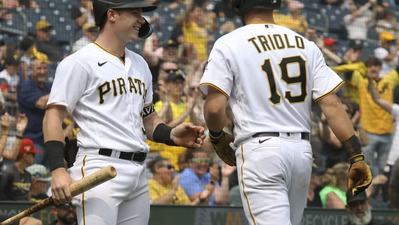 Jun 29, 2023; Pittsburgh, Pennsylvania, USA; Pittsburgh Pirates right fielder Henry Davis (left) congratulates third baseman Jared Triolo (19) after Triolo scored a run on a San Diego Padres error during the seventh inning at PNC Park. Pittsburgh won 5-4. Mandatory Credit: Charles LeClaire-USA TODAY Sports