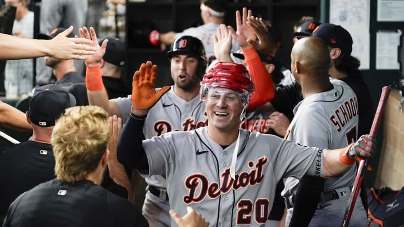 Jun 29, 2023; Arlington, Texas, USA; Detroit Tigers first baseman Spencer Torkelson (20) is greeted in the dugout by teammates and presented with a hockey helmet and stick after hitting a three run home run during the eighth inning against the Texas Rangers at Globe Life Field. Mandatory Credit: Raymond Carlin III-USA TODAY Sports