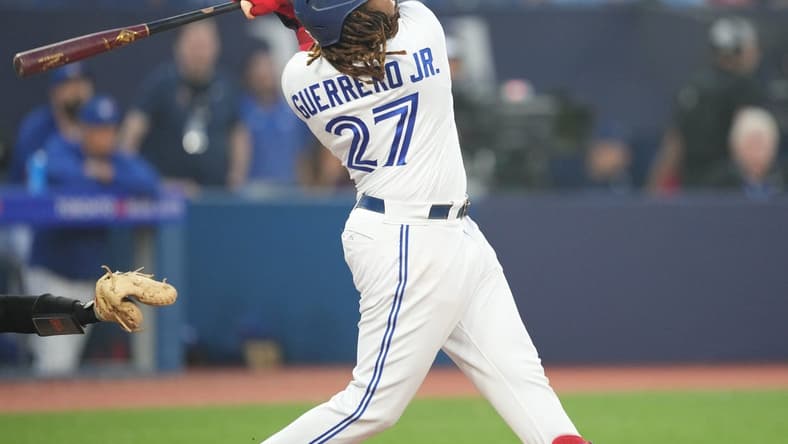 Jun 29, 2023; Toronto, Ontario, CAN; Toronto Blue Jays designated hitter Vladimir Guerrero Jr. (27) hits a two run home run against the San Francisco Giants during the sixth inning at Rogers Centre. Mandatory Credit: Nick Turchiaro-USA TODAY Sports
