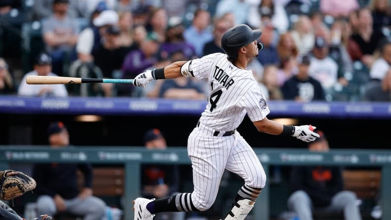 Jun 30, 2023; Denver, Colorado, USA; Colorado Rockies shortstop Ezequiel Tovar (14) watches his ball on a three run home run in the sixth inning against the Detroit Tigers at Coors Field. Mandatory Credit: Isaiah J. Downing-USA TODAY Sports