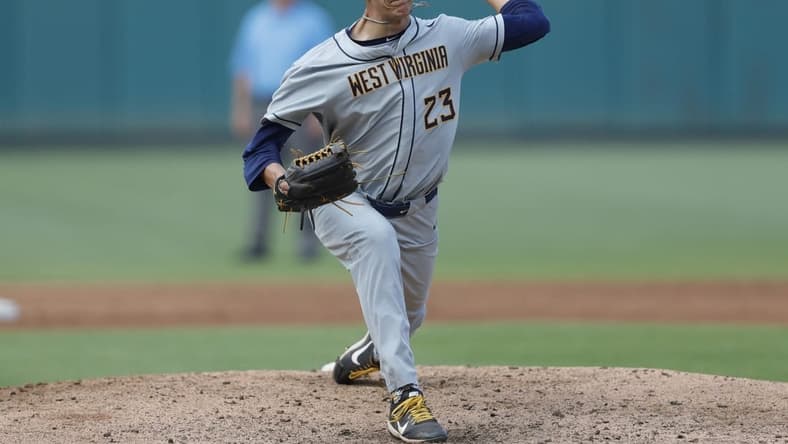 May 26, 2021; Oklahoma City, Oklahoma, USA; West Virginia pitcher Jackson Wolf (23) delivers a pitch to Texas during the Big 12 Conference Baseball Tournament at Chickasaw Bricktown Ballpark. Mandatory Credit: Alonzo Adams-USA TODAY Sports