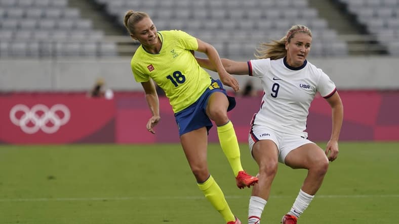 Sweden forward Fridolina Rolfo (18) collides with United States midfielder Lindsey Horan (9) during the first half in Group G play during the Tokyo 2020 Olympic Summer Games at Tokyo Stadium. Mandatory Credit: Jack Gruber-USA TODAY Network