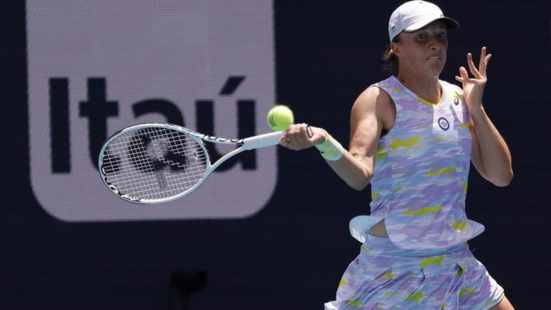 Apr 2, 2022; Miami Gardens, FL, USA; Iga Swiatek (POL) hits a forehand against Naomi Osaka (JPN)(not pictured) in the women's singles final in the Miami Open at Hard Rock Stadium. Mandatory Credit: Geoff Burke-USA TODAY Sports