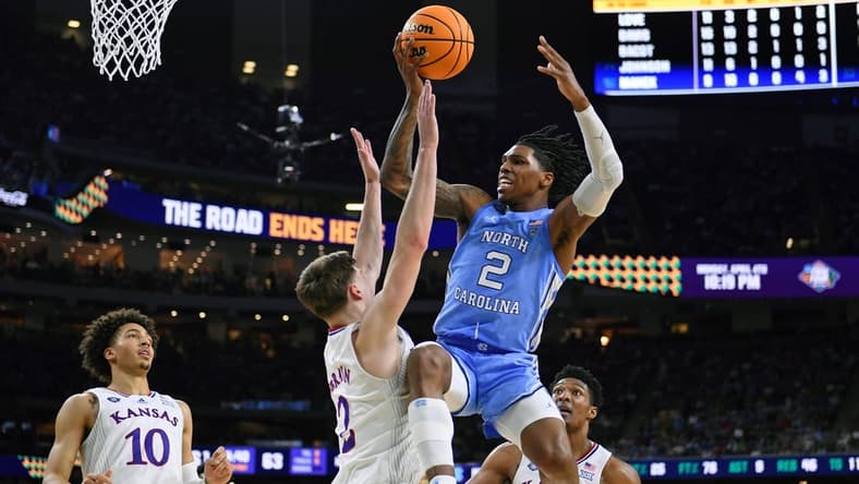 Apr 4, 2022; New Orleans, LA, USA; North Carolina Tar Heels guard Caleb Love (2) loses control of the ball while defended by Kansas Jayhawks guard Christian Braun (2) during the second half during the 2022 NCAA men's basketball tournament Final Four championship game at Caesars Superdome. Mandatory Credit: Bob Donnan-USA TODAY Sports