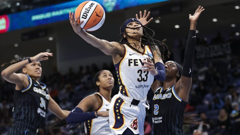 May 24, 2022; Chicago, Illinois, USA; Indiana Fever guard Destanni Henderson (33) goes to the basket against Chicago Sky guard Kahleah Copper (2) during the second half at Wintrust Arena. Mandatory Credit: Kamil Krzaczynski-USA TODAY Sports