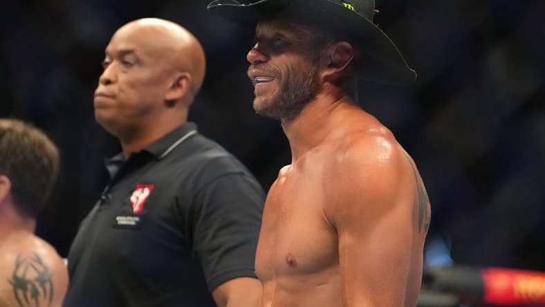 Jul 2, 2022; Las Vegas, Nevada, USA; Donald Cerrone (blue gloves) reacts after a loss to Jim Miller (red gloves) during UFC 276 at T-Mobile Arena. Mandatory Credit: Stephen R. Sylvanie-USA TODAY Sports