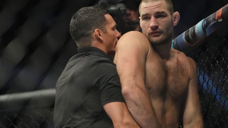 Jul 2, 2022; Las Vegas, Nevada, USA; Sean Strickland (red gloves) reacts after a loss to Alex Pereira (blue gloves) fight in a bout during UFC 276 at T-Mobile Arena. Mandatory Credit: Stephen R. Sylvanie-USA TODAY Sports