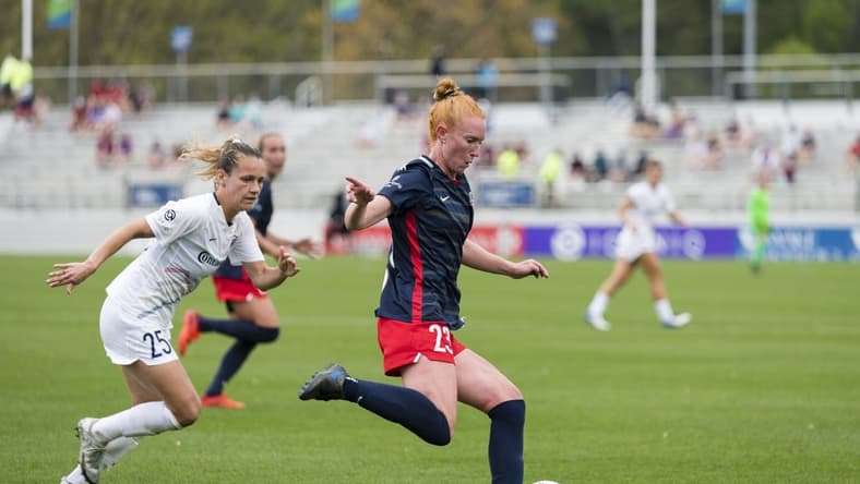 CARY, NC - APRIL 10: Meredith Speck #25 of the NC Courage gives chase as Tori Huster #23 of the Washington Spirit passes the ball during a game between Washington Spirit and North Carolina Courage at Sahlen's Stadium at WakeMed Soccer Park on April 10, 2021 in Cary, North Carolina.