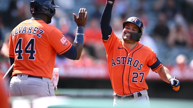 Sep 4, 2022; Anaheim, California, USA; Houston Astros second baseman Jose Altuve (27) is congratulated by left fielder Yordan Alvarez (44) after hitting a two-run home run against the Los Angeles Angels during the seventh inning at Angel Stadium. Mandatory Credit: Orlando Ramirez-USA TODAY Sports
