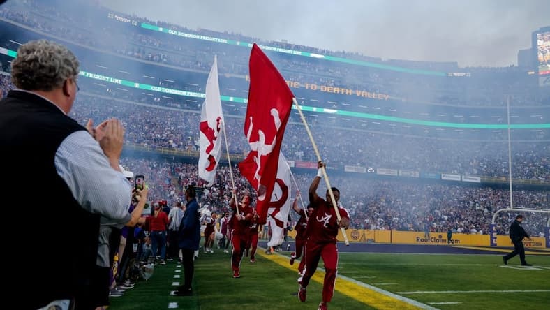 Nov 5, 2022; Baton Rouge, Louisiana, USA; Alabama Crimson Tide cheerleaders lead out the players from the tunnel to start the game against the LSU Tigers before the first half at Tiger Stadium. Mandatory Credit: Stephen Lew-USA TODAY Sports