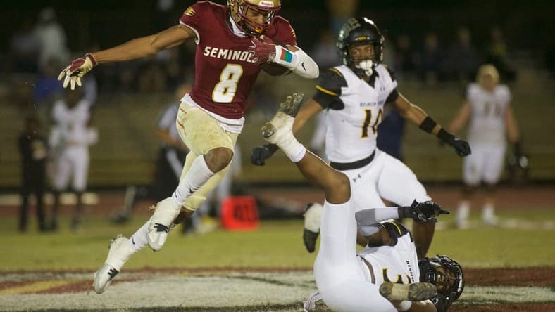 Florida High junior Micahi Danzy (8) leaps through the air in the Class 2S state semifinal matchup between Florida High and Bishop Verot on Dec. 2, 2022, at Mike Hickman Stadium. The Seminoles won, 38-28.
J9t8323