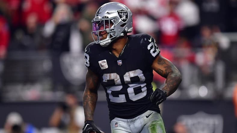 January 1, 2023; Paradise, Nevada, USA; Las Vegas Raiders running back Josh Jacobs (28) scores a touchdown against the San Francisco 49ers during the second half at Allegiant Stadium. Mandatory Credit: Gary A. Vasquez-USA TODAY Sports