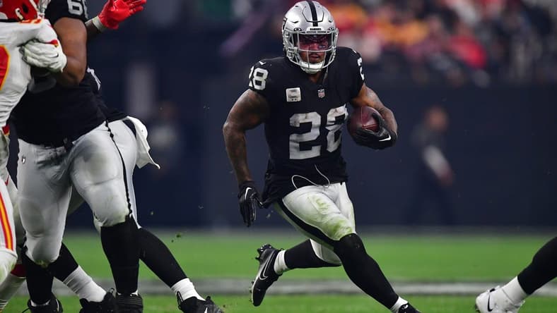 Jan 7, 2023; Paradise, Nevada, USA; Las Vegas Raiders running back Josh Jacobs (28) runs the ball against the Kansas City Chiefs during the second half at Allegiant Stadium. Mandatory Credit: Gary A. Vasquez-USA TODAY Sports