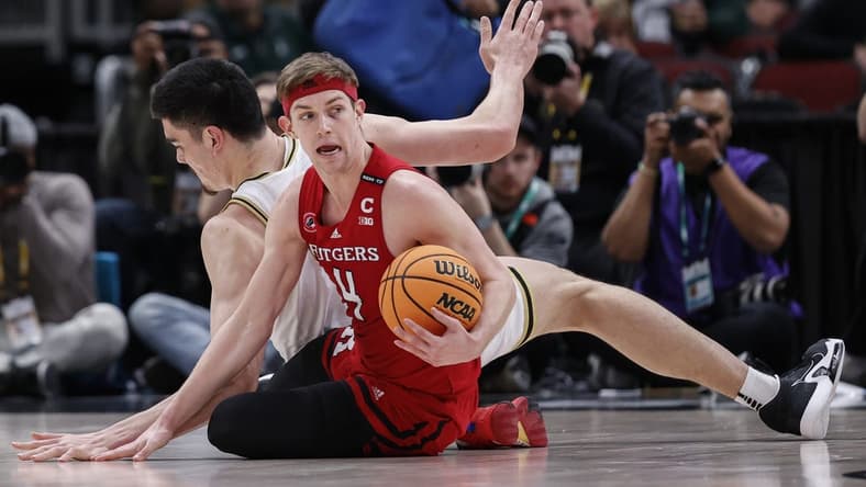 Mar 10, 2023; Chicago, IL, USA; Rutgers Scarlet Knights guard Paul Mulcahy (4) looks to pass the ball away from Purdue Boilermakers center Zach Edey (15) during the first half at United Center. Mandatory Credit: Kamil Krzaczynski-USA TODAY Sports