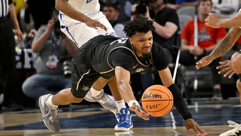 Mar 10, 2023; Fort Worth, TX, USA; UCF Knights guard Ithiel Horton (12) dives for the ball during the second half against the Memphis Tigers at Dickies Arena. Mandatory Credit: Jerome Miron-USA TODAY Sports