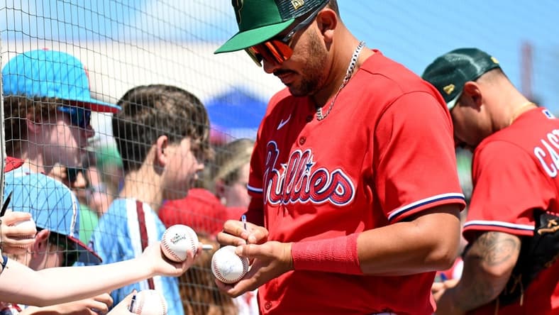 Mar 17, 2023; Clearwater, Florida, USA; Philadelphia Phillies designated hitter Darick Hall (24) signs autographs before a spring training game against the Toronto Blue Jays at BayCare Ballpark. Mandatory Credit: Jonathan Dyer-USA TODAY Sports