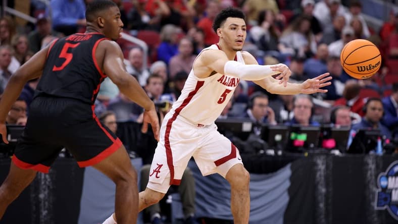 Mar 24, 2023; Louisville, KY, USA; Alabama Crimson Tide guard Jahvon Quinerly (5) passes in front of San Diego State Aztecs guard Lamont Butler (5) during the first half of the NCAA tournament round of sixteen at KFC YUM! Center. Mandatory Credit: Jordan Prather-USA TODAY Sports