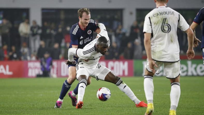 Mar 25, 2023; Washington, District of Columbia, USA; D.C. United forward Christian Benteke (20) controls the ball as New England Revolution defender Henry Kessler (4) defends in the first half at Audi Field. Mandatory Credit: Amber Searls-USA TODAY Sports