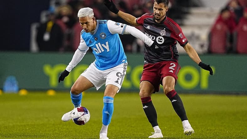 Apr 1, 2023; Toronto, Ontario, CAN; Charlotte FC forward Enzo Copetti (9) tries to control the ball against Toronto FC defender Matt Hedges (2) during the first half at BMO Field. Mandatory Credit: John E. Sokolowski-USA TODAY Sports