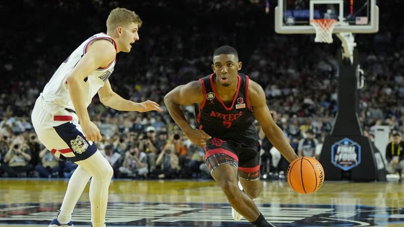 Apr 3, 2023; Houston, TX, USA; San Diego State Aztecs guard Lamont Butler (5) dribbles the ball against Connecticut Huskies guard Joey Calcaterra (3) in the national championship game of the 2023 NCAA Tournament at NRG Stadium. Mandatory Credit: Bob Donnan-USA TODAY Sports