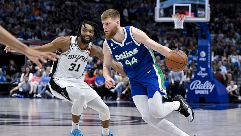 Apr 9, 2023; Dallas, Texas, USA; Dallas Mavericks forward Davis Bertans (44) drives to the basket past San Antonio Spurs forward Keita Bates-Diop (31) during the second quarter at the American Airlines Center. Mandatory Credit: Jerome Miron-USA TODAY Sports