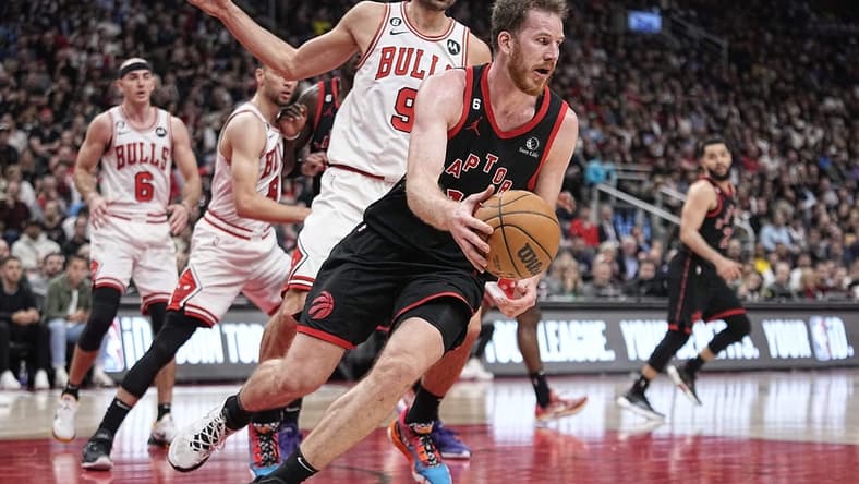 Apr 12, 2023; Toronto, Ontario, CAN; Toronto Raptors center Jakob Poeltl (19) recovers a loose ball against Chicago Bulls center Nikola Vucevic (9) during the second half of a NBA Play-In game at Scotiabank Arena. Mandatory Credit: John E. Sokolowski-USA TODAY Sports