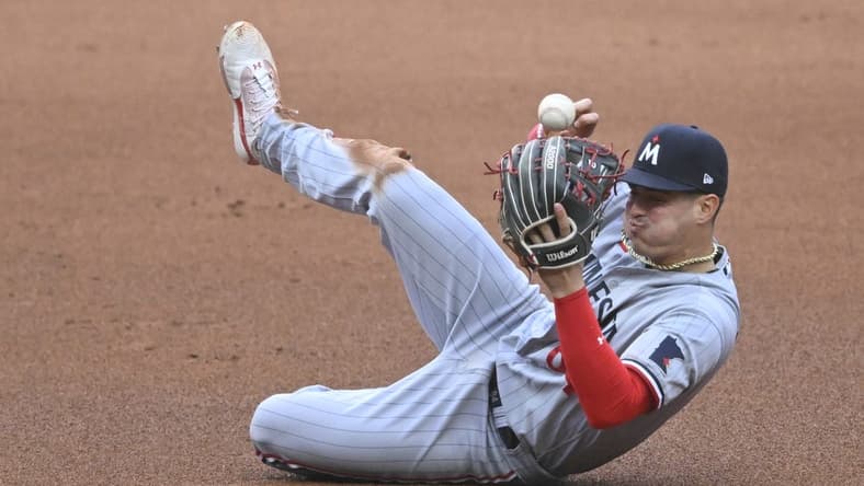 May 6, 2023; Cleveland, Ohio, USA; Minnesota Twins third baseman Jose Miranda (64) attempts to field the ball on a base hit against the Cleveland Guardians in the fourth inning at Progressive Field. Mandatory Credit: David Richard-USA TODAY Sports