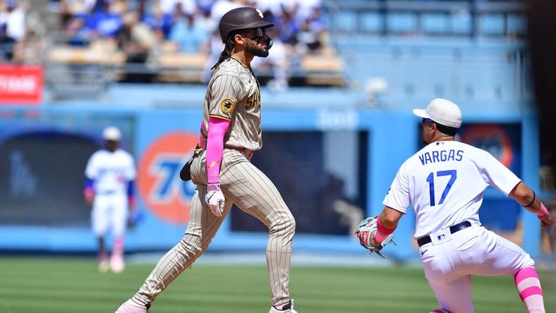 May 14, 2023; Los Angeles, California, USA; San Diego Padres right fielder Fernando Tatis Jr. (23) steals second against Los Angeles Dodgers second baseman Miguel Vargas (17) during the eighth inning at Dodger Stadium. Mandatory Credit: Gary A. Vasquez-USA TODAY Sports