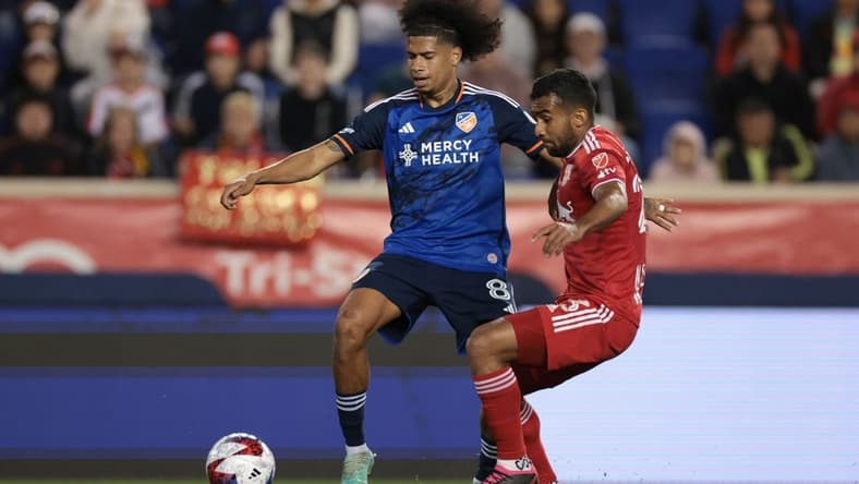 May 23, 2023; Harrison, NJ, USA; FC Cincinnati midfielder Marco Angulo (8) battles for the ball against New York Red Bulls midfielder Cristian Casseres Jr (23) during the second half at Red Bull Arena. Mandatory Credit: Vincent Carchietta-USA TODAY Sports