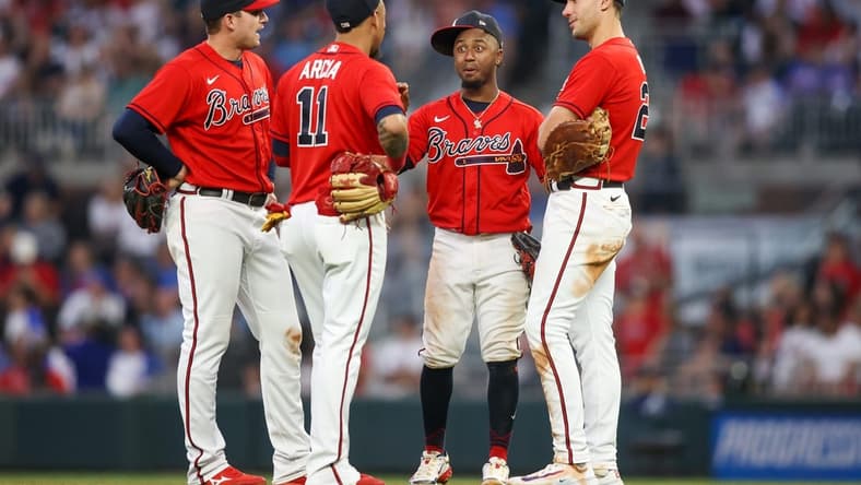 May 26, 2023; Atlanta, Georgia, USA; Atlanta Braves third baseman Austin Riley (27) and shortstop Orlando Arcia (11) and second baseman Ozzie Albies (1) and first baseman Matt Olson (28) talk during a pitching change against the Philadelphia Phillies in the sixth inning at Truist Park. Mandatory Credit: Brett Davis-USA TODAY Sports