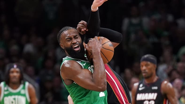 May 29, 2023; Boston, Massachusetts, USA; Boston Celtics guard Jaylen Brown (7) battles for control against Miami Heat guard Max Strus (31) in the first quarter during game seven of the Eastern Conference Finals for the 2023 NBA playoffs at TD Garden. Mandatory Credit: David Butler II-USA TODAY Sports