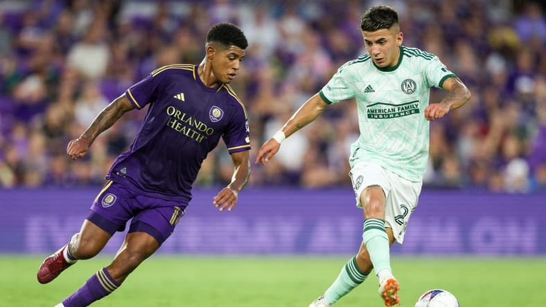 May 27, 2023; Orlando, Florida, USA;  Atlanta United FC midfielder Thiago Almada (23) controls the ball from Orlando City SC midfielder Wilder Cartagena (16) in the first half at Exploria Stadium. Mandatory Credit: Nathan Ray Seebeck-USA TODAY Sports
