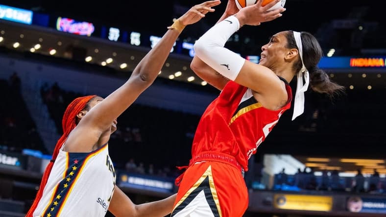 Jun 4, 2023; Indianapolis, Indiana, USA; Las Vegas Aces forward A'ja Wilson (22) shoots the ball while Indiana Fever center Aliyah Boston (7) defends in the second half at Gainbridge Fieldhouse. Mandatory Credit: Trevor Ruszkowski-USA TODAY Sports