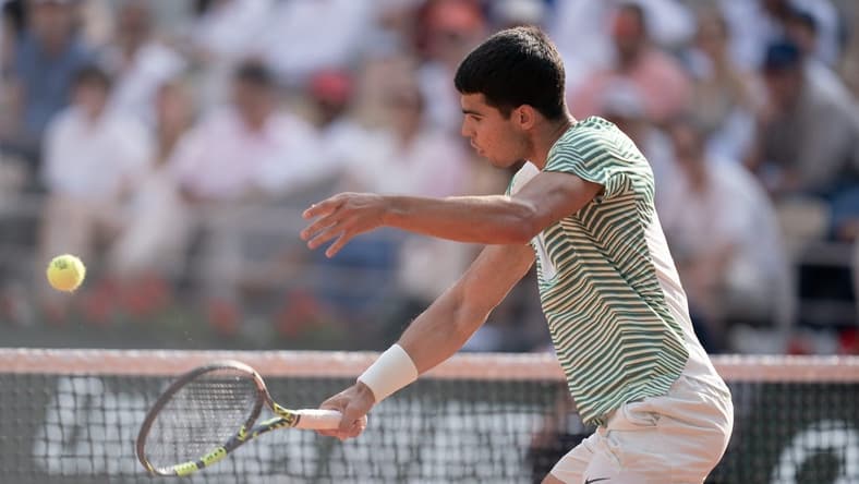 Jun 9 2023; Paris,France; Carlos Alcaraz (ESP) returns a shot during his semifinal match against Novak Djokovic (SRB) on day 13 at Stade Roland-Garros. Mandatory Credit: Susan Mullane-USA TODAY Sports