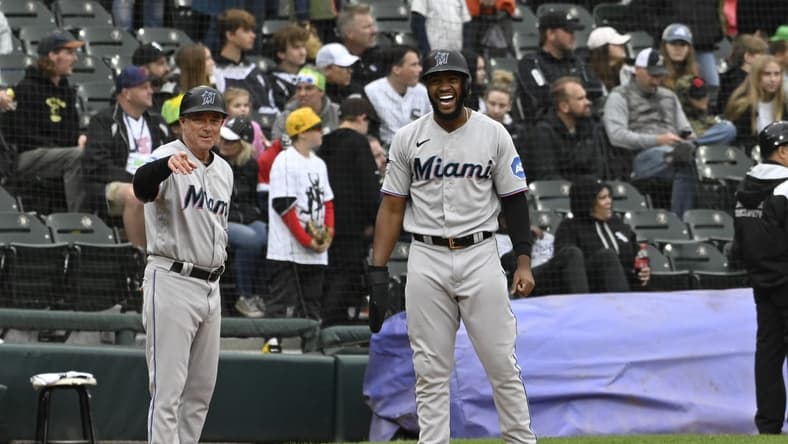 Jun 11, 2023; Chicago, Illinois, USA; Miami Marlins left fielder Bryan De La Cruz (14) yells with Miami Marlins third base/infield coach Jody Reed (33) after hitting a two RBI double against the Chicago White Sox during the ninth inning at Guaranteed Rate Field. Mandatory Credit: Matt Marton-USA TODAY Sports