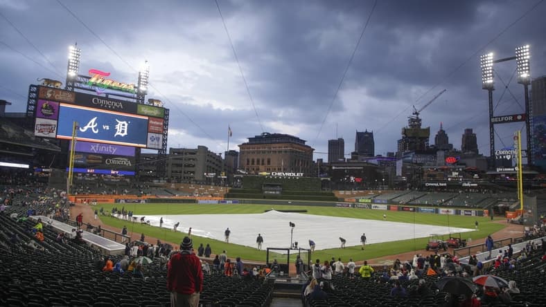 Jun 13, 2023; Detroit, Michigan, USA; The Detroit Tigers grounds crew works to put the tarp on the field during a rain delay at Comerica Park. Mandatory Credit: Brian Bradshaw Sevald-USA TODAY Sports
