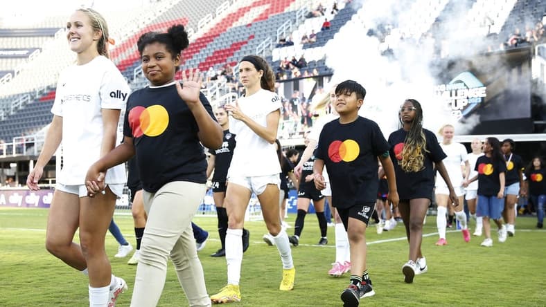 Jun 14, 2023; Washington, D.C., USA; Young fans walk with the North Carolina Courage before ether match against the Washington Spirit at Audi Field. Mandatory Credit: Amber Searls-USA TODAY Sports
