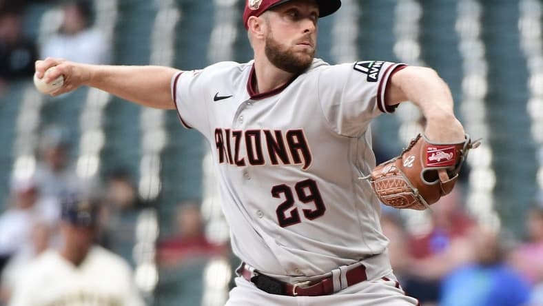 Jun 19, 2023; Milwaukee, Wisconsin, USA; Arizona Diamondbacks pitcher Merrill Kelly (29) pitches against the Milwaukee Brewers in the first inning at American Family Field. Mandatory Credit: Benny Sieu-USA TODAY Sports