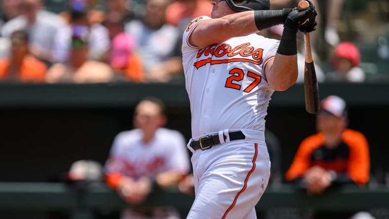 Jun 15, 2023; Baltimore, Maryland, USA; Baltimore Orioles catcher James McCann (27) hits a single during the fifth inning against the Toronto Blue Jays at Oriole Park at Camden Yards. Mandatory Credit: Reggie Hildred-USA TODAY Sports