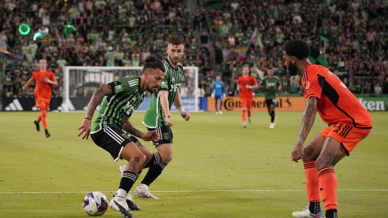 Jun 24, 2023; Austin, Texas, USA; Austin FC defender Amro Tarek (31) dribbles the ball against the Houston Dynamo defender Micael (31) during the second half at Q2 Stadium. Mandatory Credit: Dustin Safranek-USA TODAY Sports