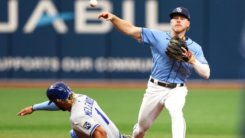 Jun 25, 2023; St. Petersburg, Florida, USA;  Tampa Bay Rays second baseman Taylor Walls (6) turns a double play against the Kansas City Royals in the second inning at Tropicana Field. Mandatory Credit: Nathan Ray Seebeck-USA TODAY Sports