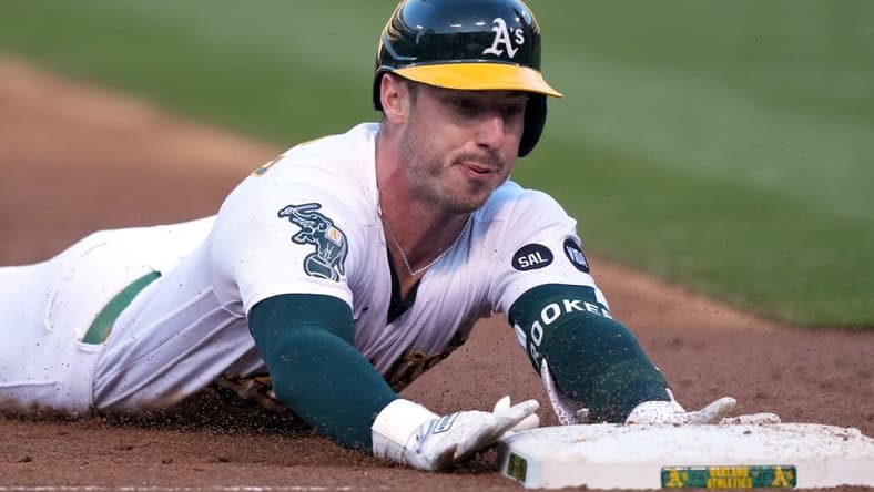 Jun 30, 2023; Oakland, California, USA; Oakland Athletics right fielder Brent Rooker (25) slides into third base for a triple against the Chicago White Sox during the third inning at Oakland-Alameda County Coliseum. Mandatory Credit: Darren Yamashita-USA TODAY Sports