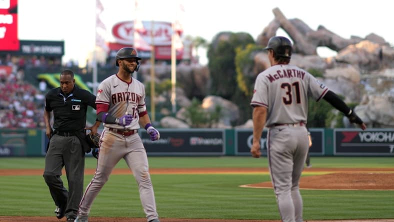 Jun 30, 2023; Anaheim, California, USA; Arizona Diamondbacks designated hitter Lourdes Gurriel Jr. (12) celebrates with right fielder Jake McCarthy (31) after hitting a grand slam home run in the second inning against the Los Angeles Angels at Angel Stadium. Mandatory Credit: Kirby Lee-USA TODAY Sports