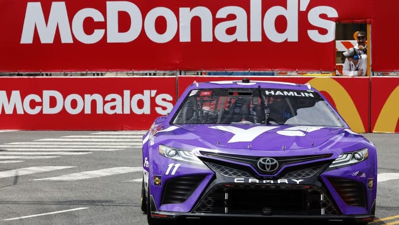 Jul 1, 2023; Chicago, Illinois, USA; NASCAR Cup Series driver Denny Hamlin (11) drives along Grant Park during practice and qualifying for the Chicago Street Race. Mandatory Credit: Mike Dinovo-USA TODAY Sports