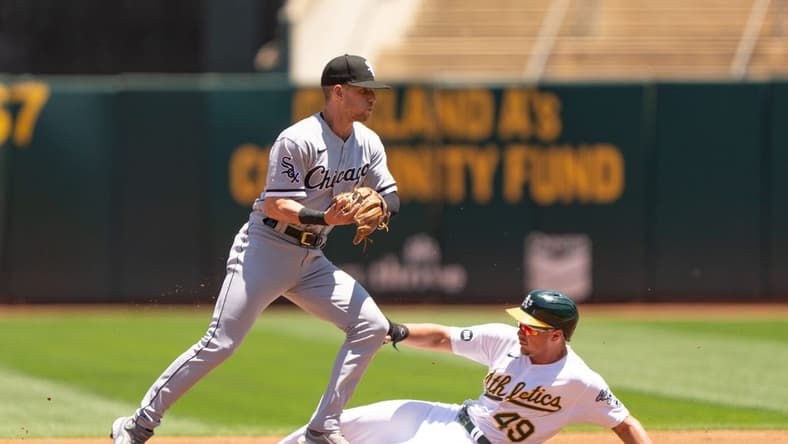 Jul 1, 2023; Oakland, California, USA; Chicago White Sox shortstop Zach Remillard (28) force tags Oakland Athletics first baseman Ryan Noda (49) during the second inning at Oakland-Alameda County Coliseum. Mandatory Credit: Stan Szeto-USA TODAY Sports